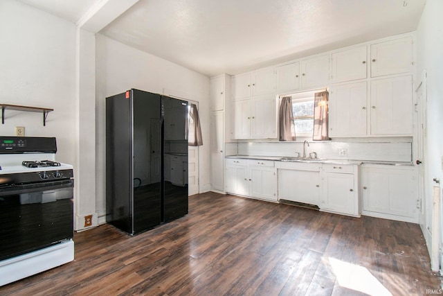 kitchen featuring black fridge, dark hardwood / wood-style flooring, white cabinetry, and white range with gas cooktop