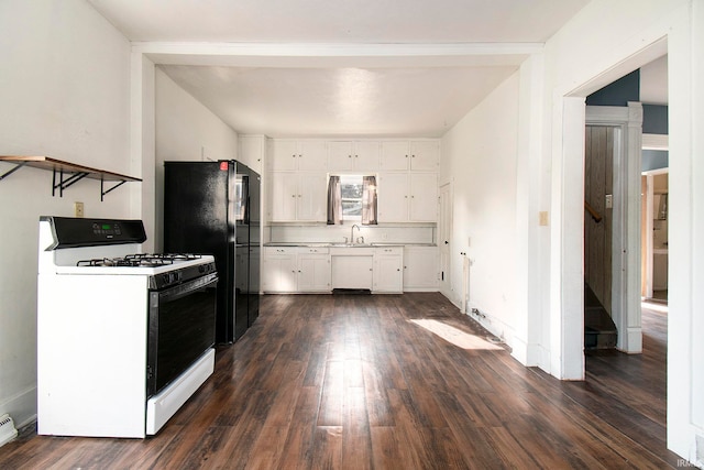 kitchen with black refrigerator, white gas range, dark hardwood / wood-style floors, and white cabinetry