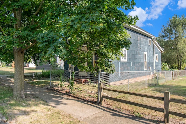 view of side of home with a lawn