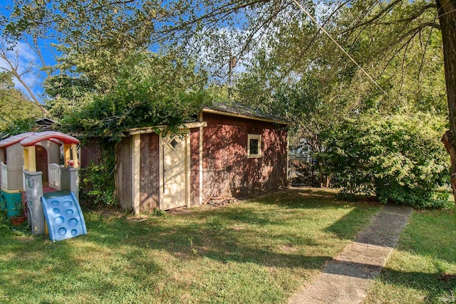 view of outdoor structure featuring a lawn