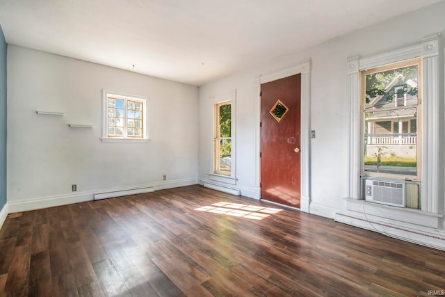 foyer entrance featuring cooling unit, a baseboard radiator, dark hardwood / wood-style floors, and a healthy amount of sunlight