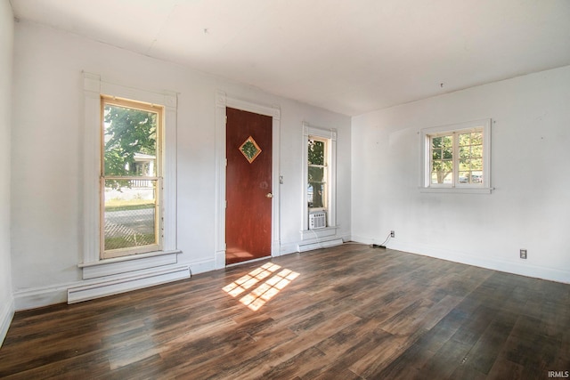 foyer entrance featuring cooling unit, a baseboard radiator, and dark hardwood / wood-style floors