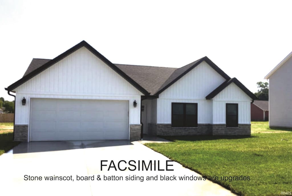 view of front of property featuring a front lawn and a garage