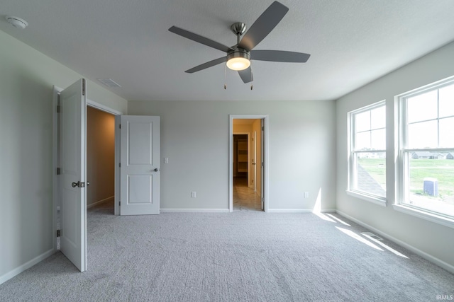 unfurnished bedroom with ceiling fan and light carpet