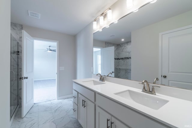 bathroom featuring vanity, ceiling fan, and a shower with door