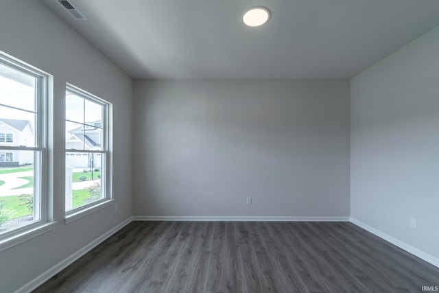 unfurnished room with dark hardwood / wood-style flooring