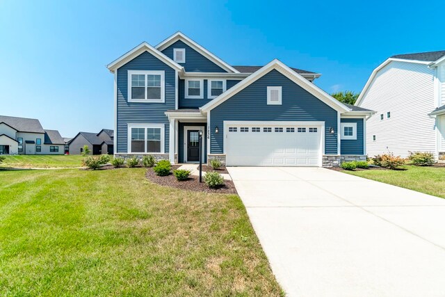 craftsman-style home featuring a garage and a front yard