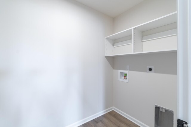 washroom with hookup for a washing machine, hookup for an electric dryer, and hardwood / wood-style flooring