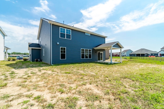 rear view of property with a yard