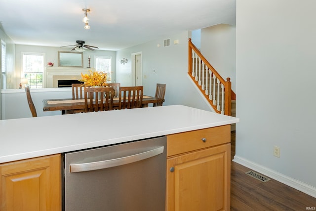 kitchen with ceiling fan, dark hardwood / wood-style floors, and stainless steel dishwasher