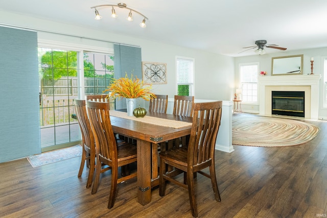 dining area featuring dark wood-type flooring, ceiling fan, and a healthy amount of sunlight