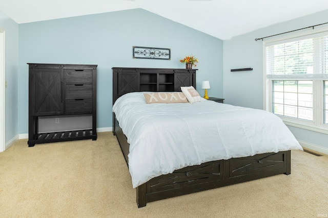 carpeted bedroom featuring vaulted ceiling