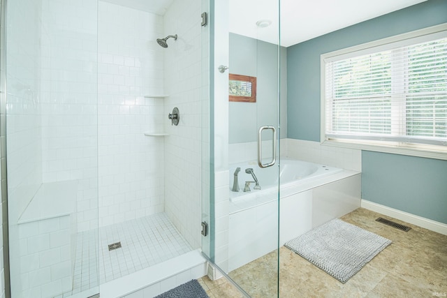 bathroom with tile patterned flooring and shower with separate bathtub