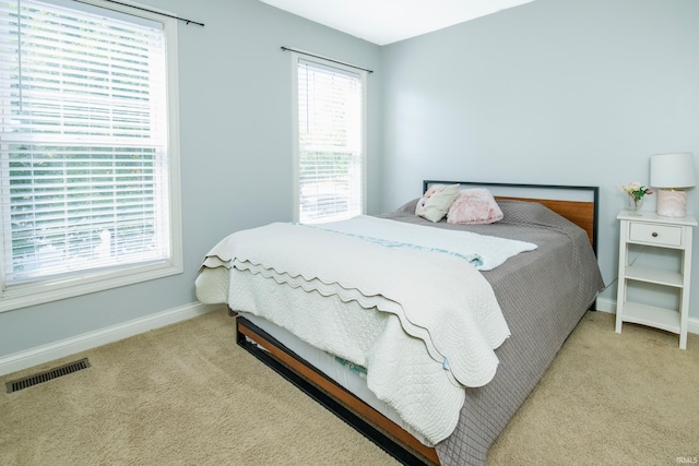 bedroom featuring light carpet