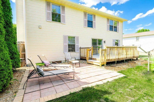 back of house featuring a yard, a patio, and a deck