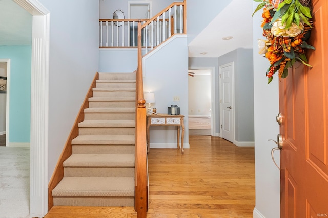 stairs featuring hardwood / wood-style floors