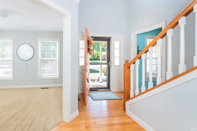 entrance foyer featuring light wood-type flooring and a healthy amount of sunlight