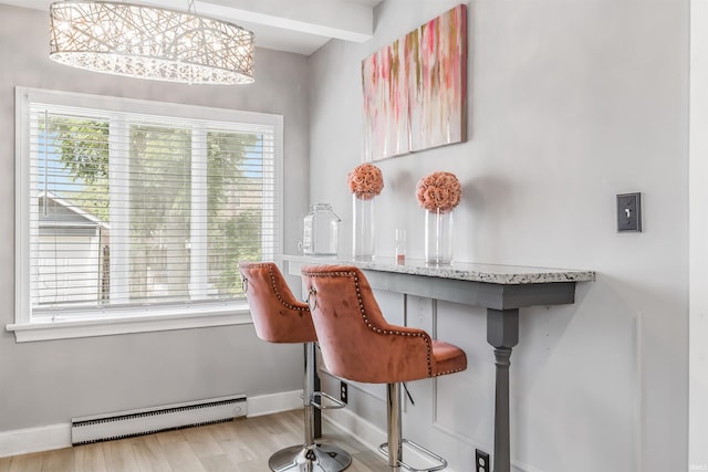 bar with beam ceiling, pendant lighting, a baseboard radiator, and light hardwood / wood-style floors