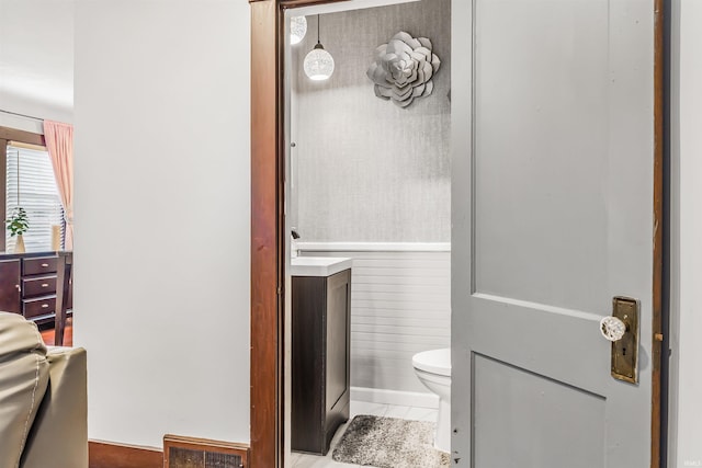 bathroom with toilet and tile patterned flooring