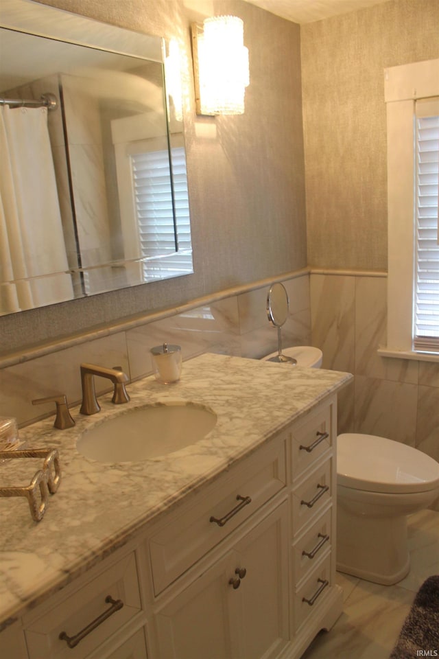 bathroom with vanity, tasteful backsplash, tile patterned flooring, tile walls, and toilet