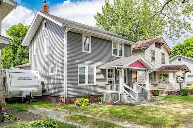 view of front facade with covered porch and a front yard