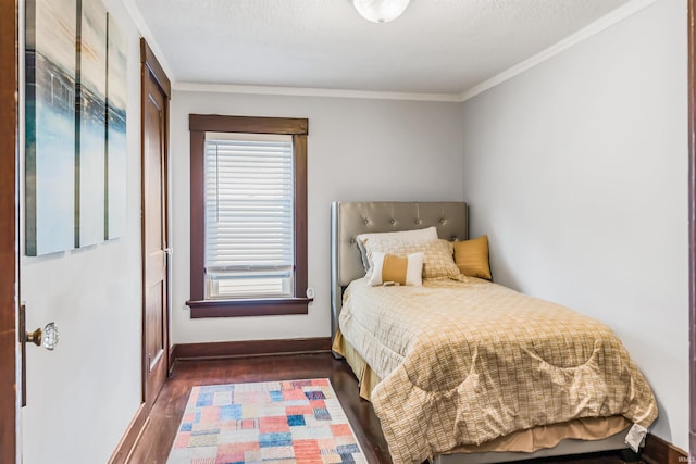 bedroom with ornamental molding and dark hardwood / wood-style flooring