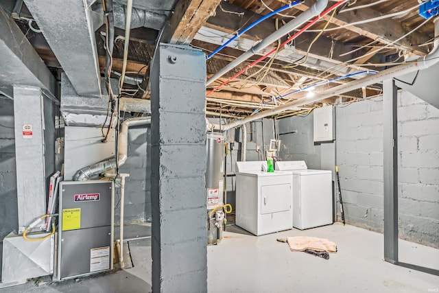 basement with washing machine and dryer and water heater