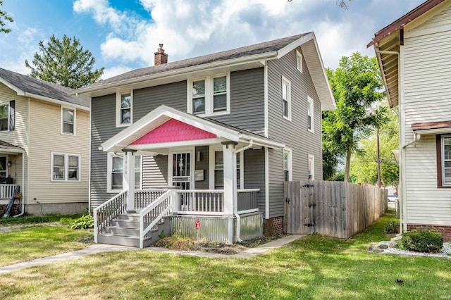 view of front of house with a front yard and a porch