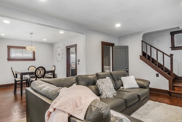 living room featuring dark wood-type flooring and a chandelier