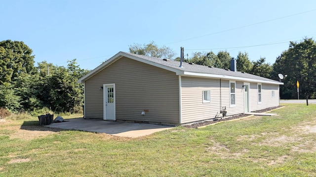 view of side of home featuring a lawn and a patio