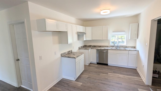 kitchen featuring light wood-type flooring, sink, stainless steel dishwasher, and white cabinets