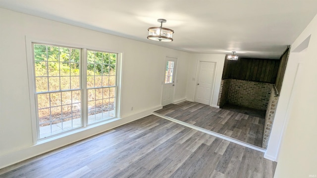 interior space featuring dark hardwood / wood-style floors and a brick fireplace