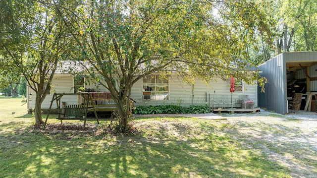 view of front of property featuring a front lawn and a deck