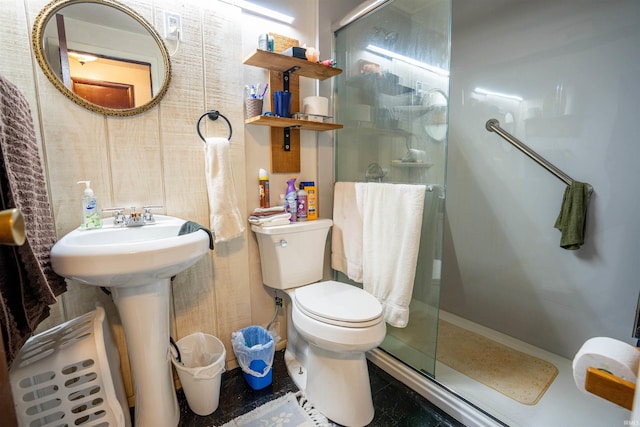 bathroom with tile patterned flooring, toilet, and a shower with door