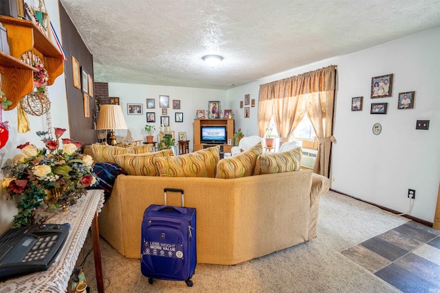 carpeted living room featuring a textured ceiling