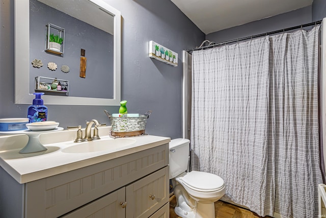 bathroom with vanity, toilet, a shower with curtain, and parquet flooring