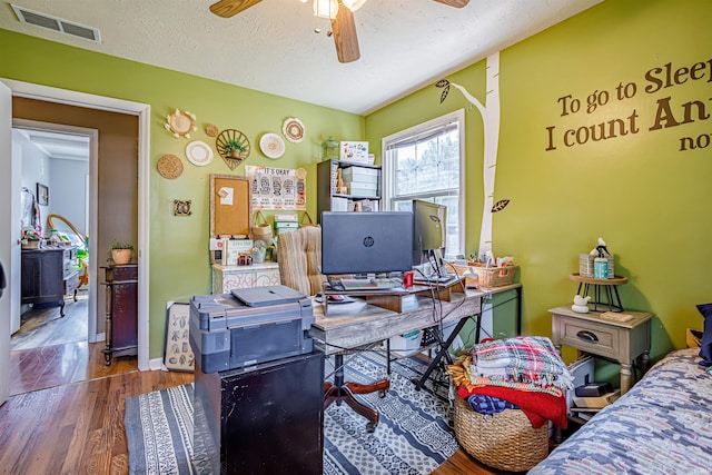 office space with hardwood / wood-style floors, ceiling fan, and a textured ceiling