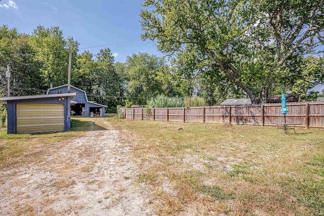 view of yard with a garage and an outdoor structure