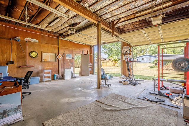 garage with a garage door opener and wooden walls