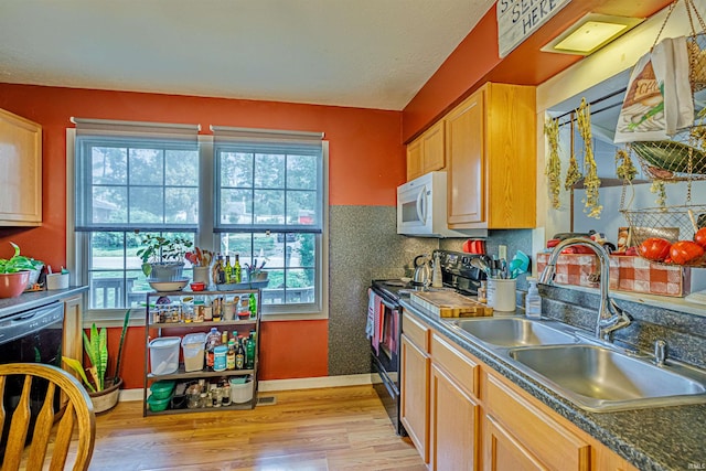 kitchen featuring black appliances, light hardwood / wood-style flooring, sink, and light brown cabinets