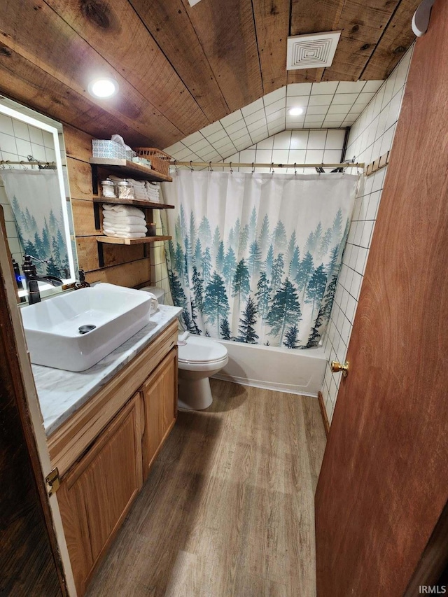 full bathroom featuring hardwood / wood-style flooring, lofted ceiling, shower / tub combo, vanity, and toilet