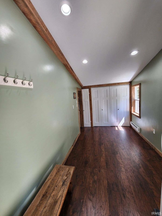 corridor featuring hardwood / wood-style floors and a baseboard heating unit