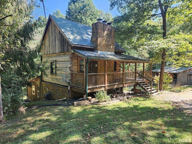 rear view of property with a lawn