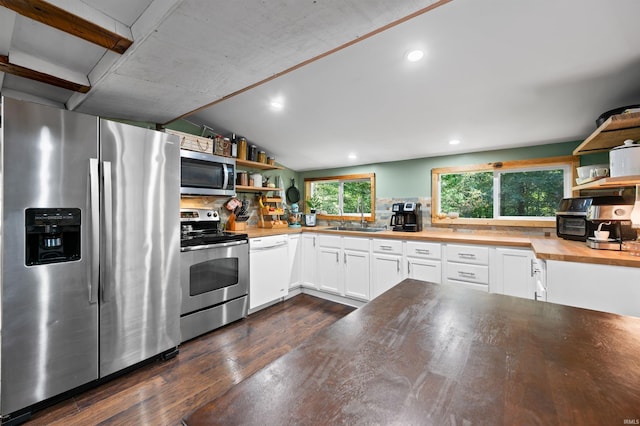 kitchen with white cabinets, lofted ceiling, dark wood-type flooring, stainless steel appliances, and butcher block counters