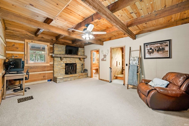 living room with beam ceiling, ceiling fan, light colored carpet, and a fireplace