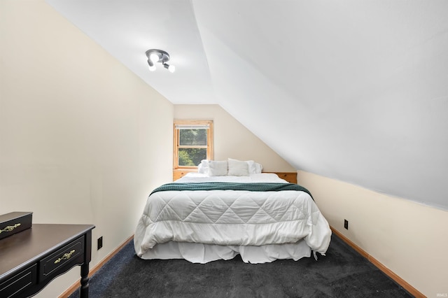 bedroom with vaulted ceiling and carpet floors