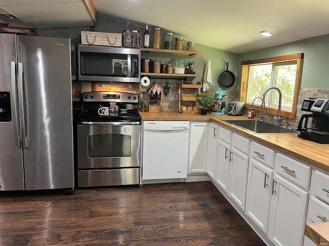 kitchen with sink, dark wood-type flooring, white cabinetry, stainless steel appliances, and butcher block counters