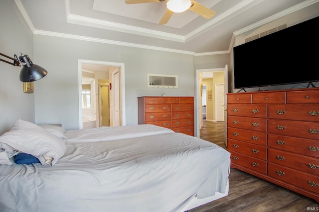 bedroom featuring ornamental molding, ceiling fan, a tray ceiling, and dark hardwood / wood-style floors