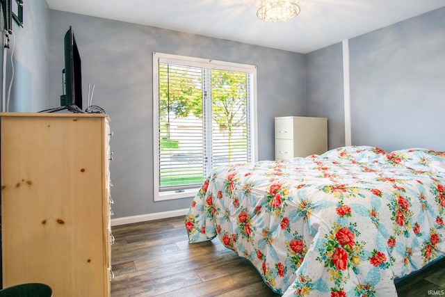 bedroom with dark hardwood / wood-style flooring