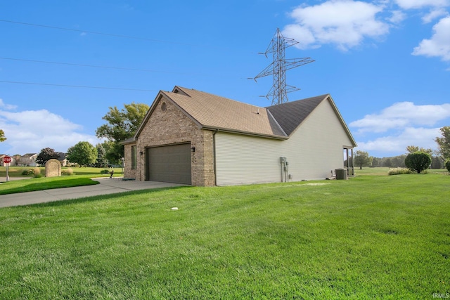 view of side of property featuring a garage, central AC unit, and a yard